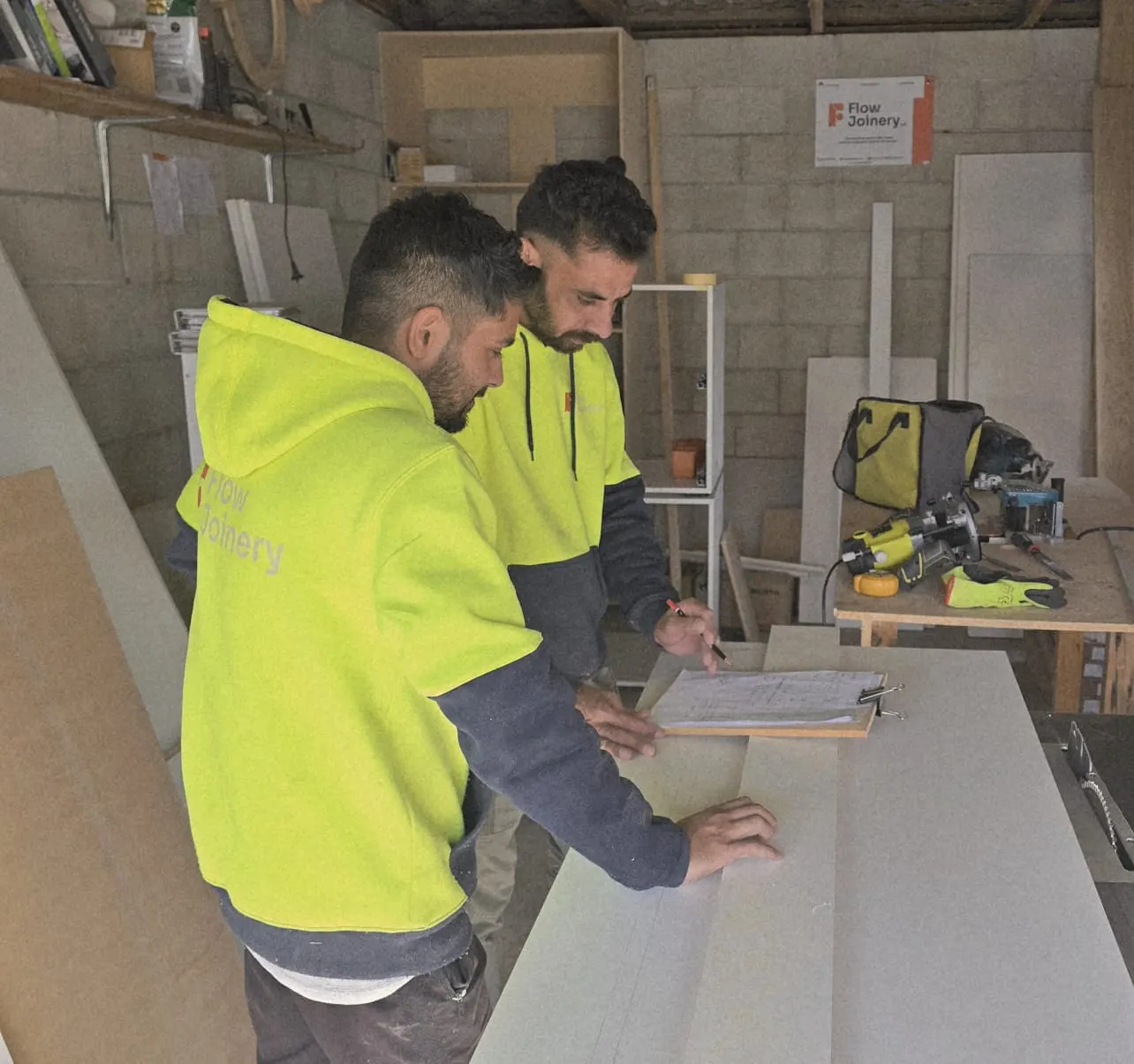 The Flow Joinery team reviewing project plans in the Gisborne workshop